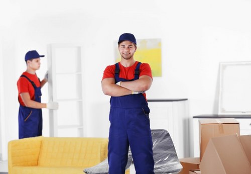 Worker using careful lifting techniques during a removal job
