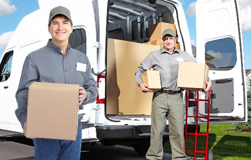 Local movers loading furniture near a Kingston residential street