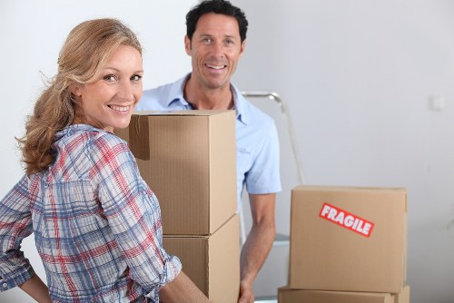 Trained removals staff handling boxed items safely during a man and van move