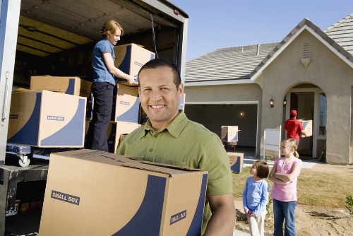 Removal team carrying boxes through a home during a Kingston upon Thames move